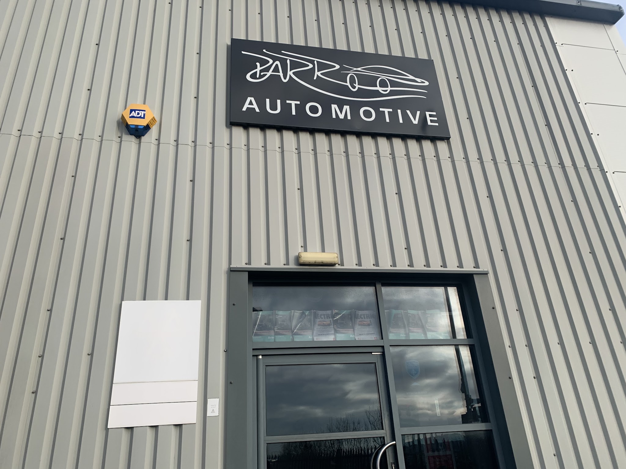 The black Parr Automotive sign above the entrance, on grey steel cladding